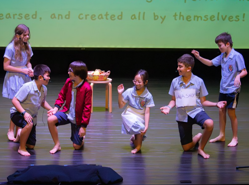 Young performers deliver their lines with confidence during a class play.