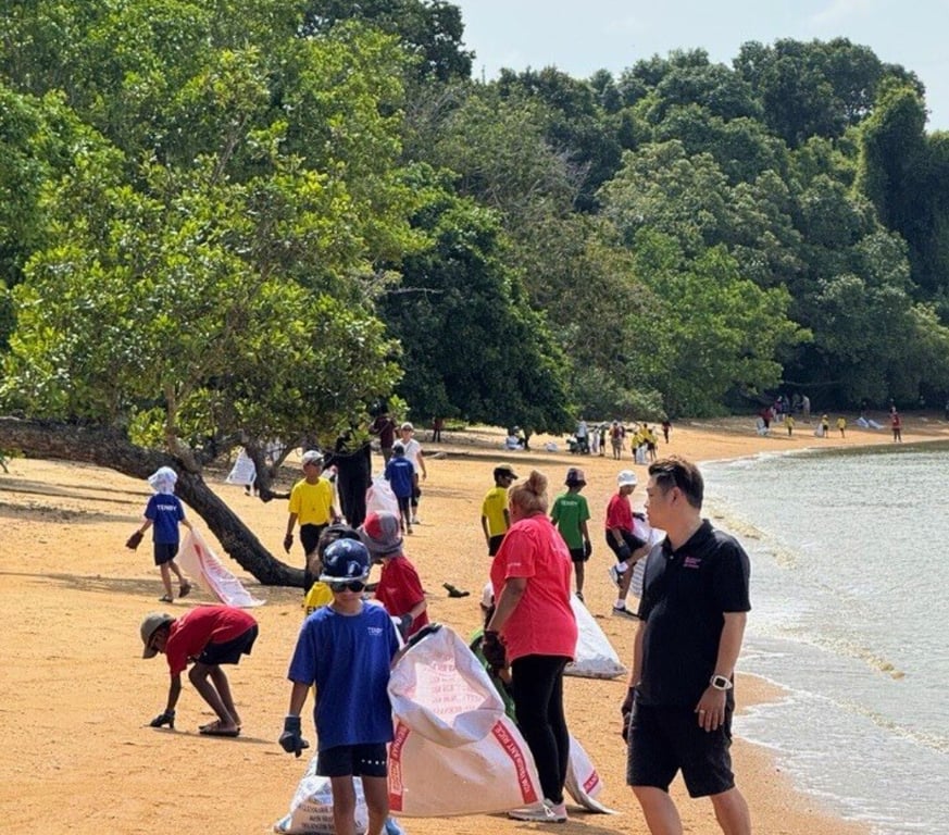 Students clearing litter on the beach, as part of their outdoor education activities.