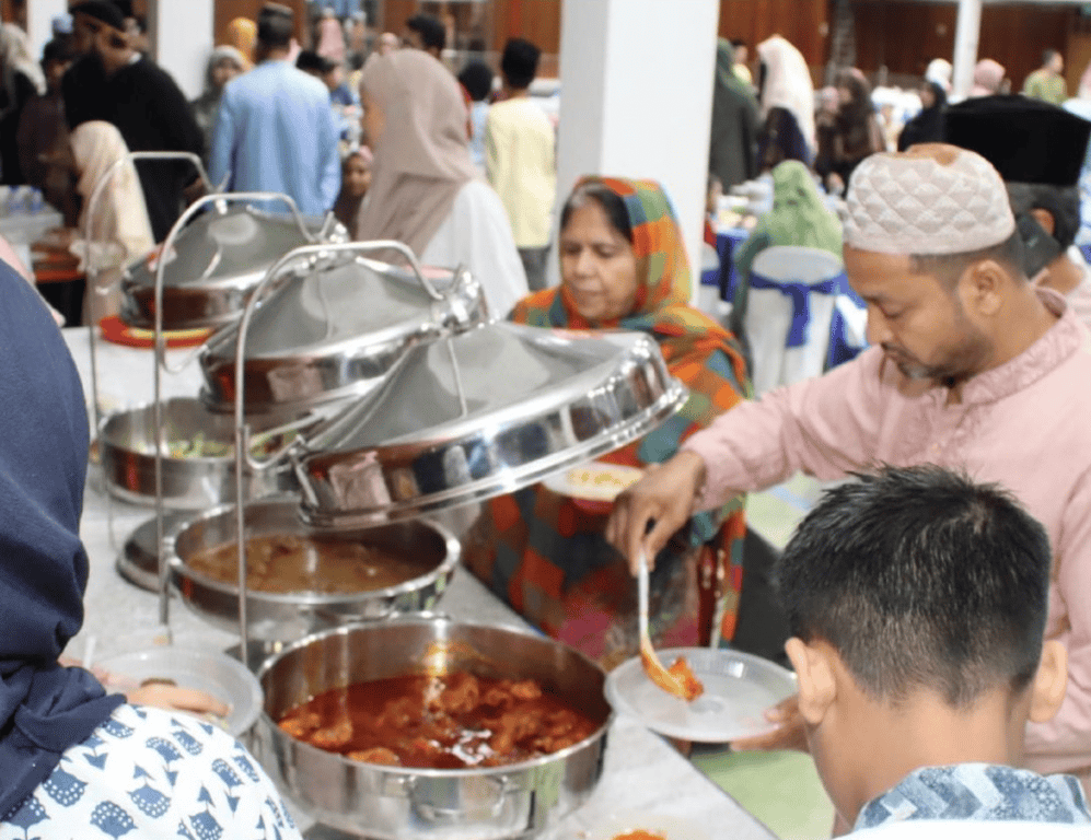 Families enjoying in the communal iftar arranged by the school.