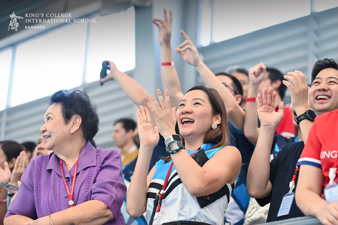 Parents cheering on swimmers at the King’s Bangkok Championship.