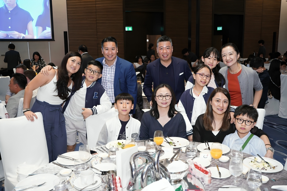 Parents and students share memories together at the school dinner.