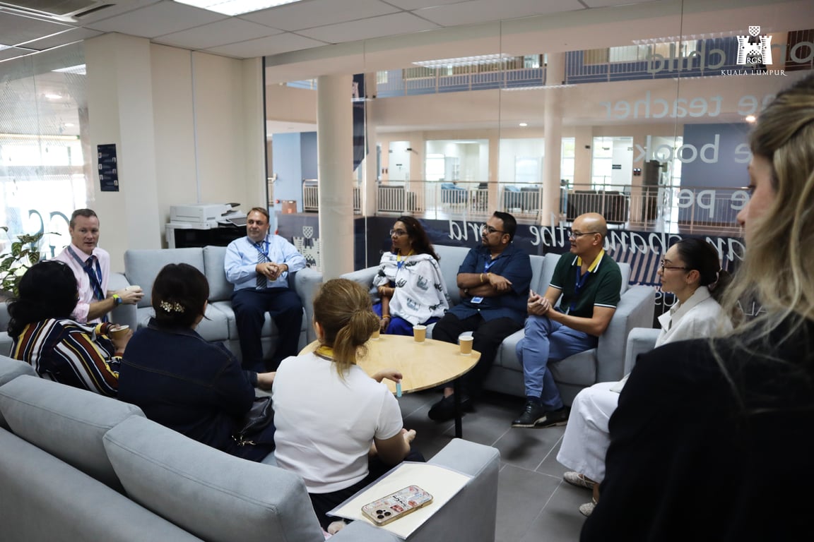 Parents attending a coffee morning discussion with the school principal.