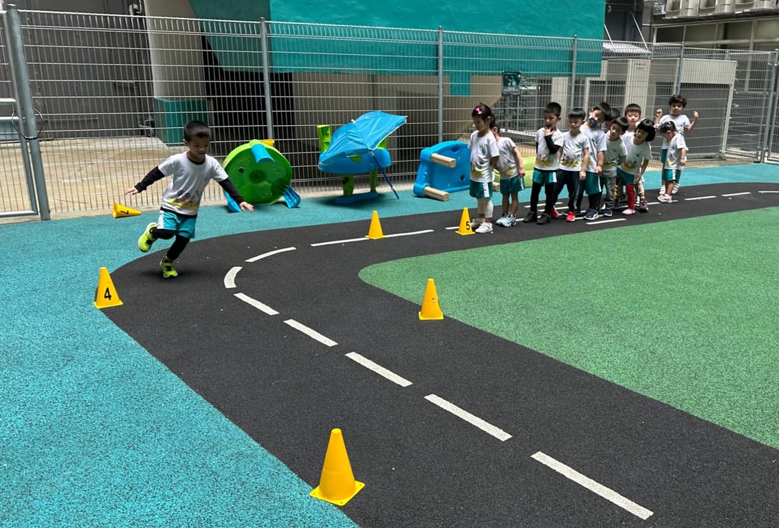 Students taking on an obstacle course in the outdoor play area during a lesson