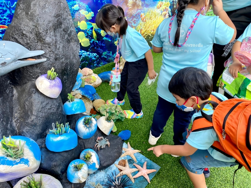 Children observing sea creatures at Marine Research Center.