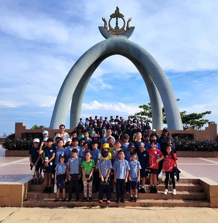 ISB students pose for a group photo during a field trip to the Billionth Barrel Monument.