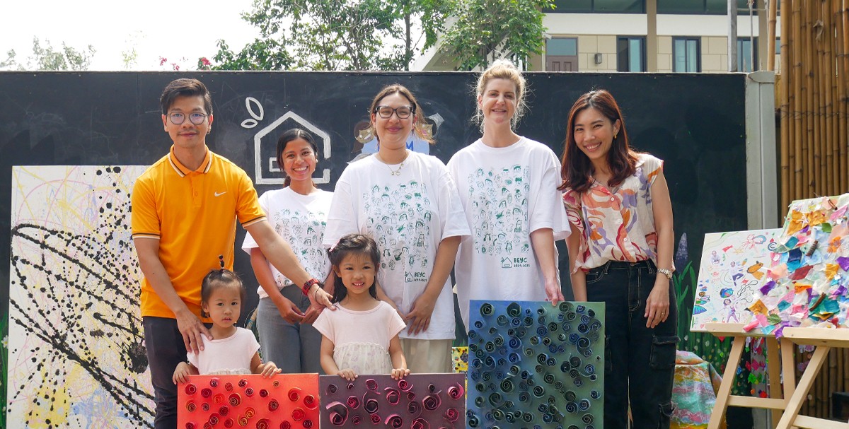 Parents posing with the teachers at a charity event.