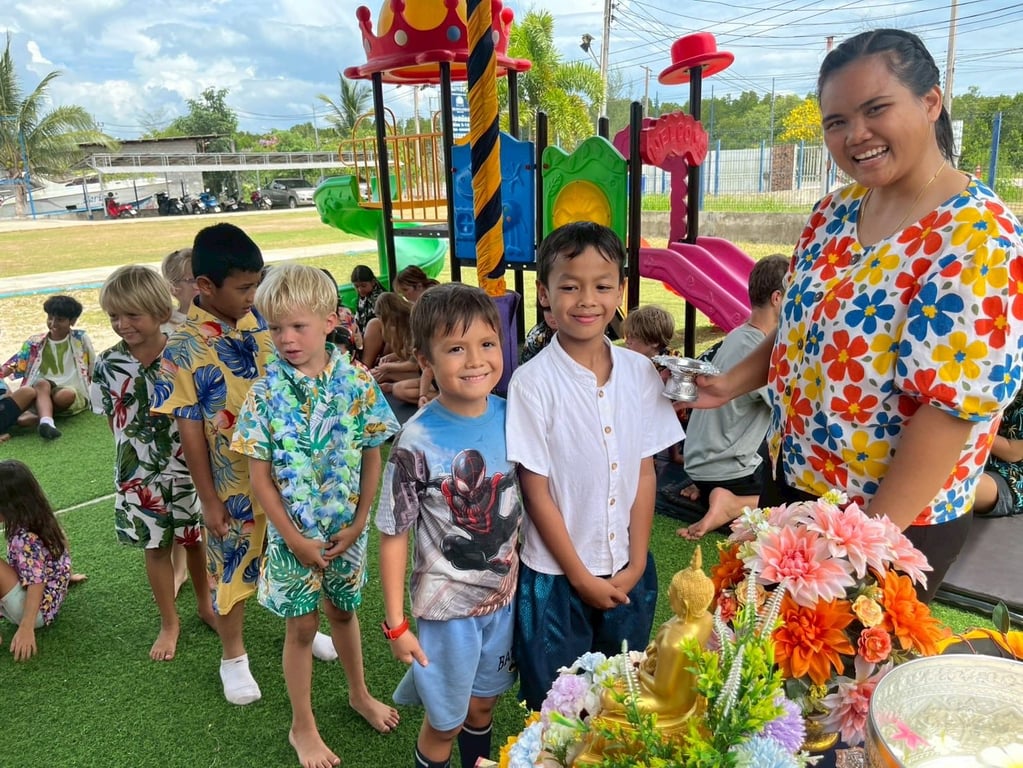 Students in line for a Songkran celebration activity on the playground.