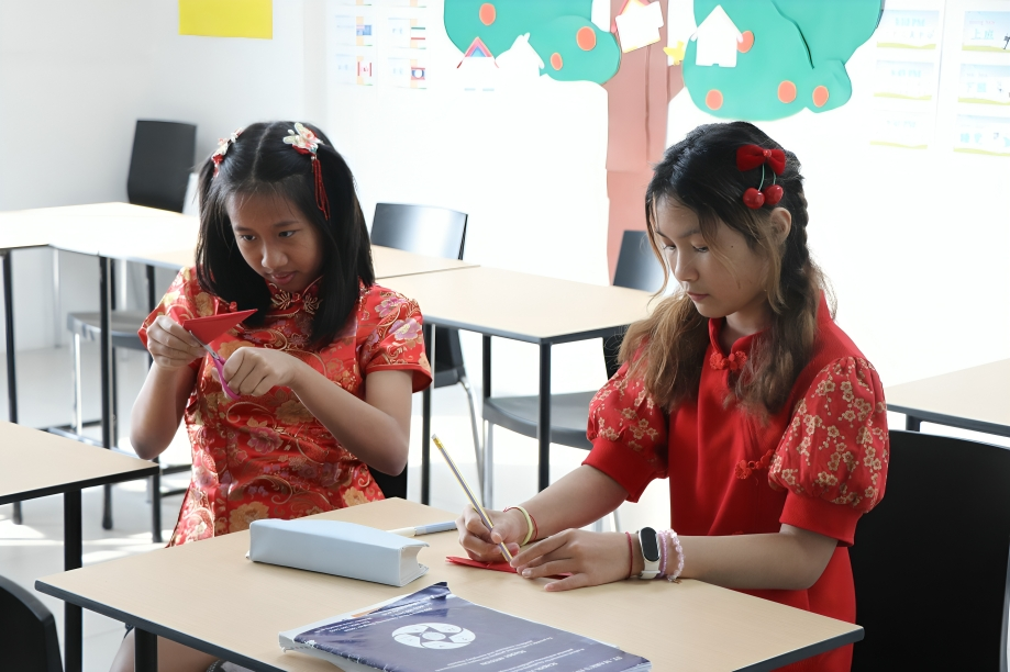 Students create crafts during a cultural celebration.