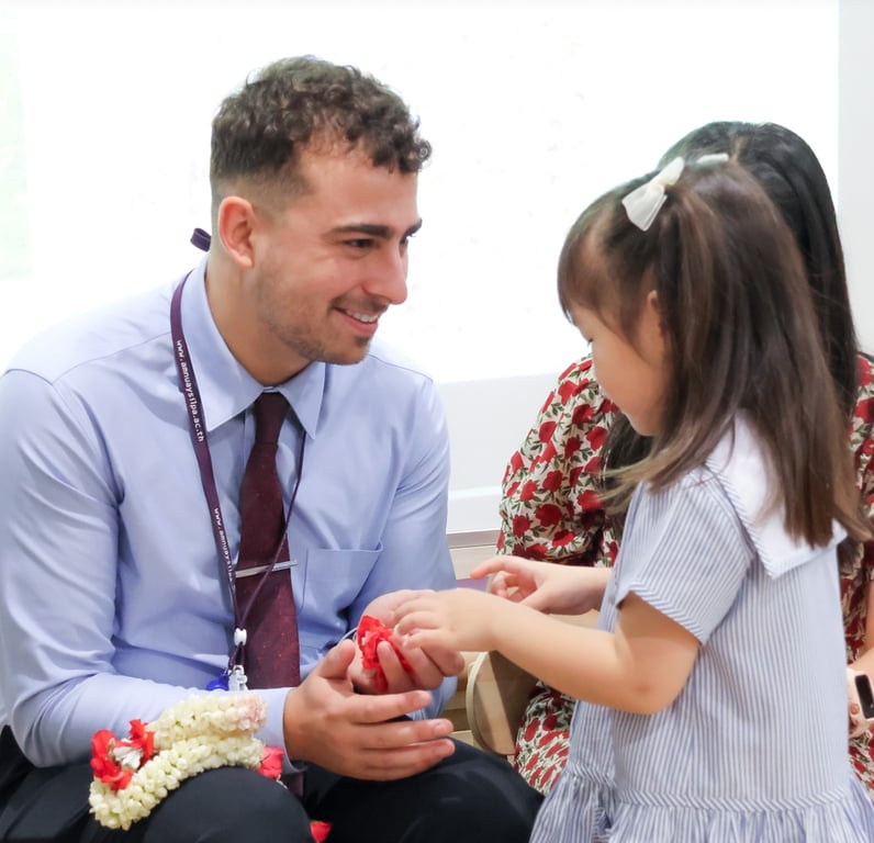 A student honoring one of the teachers at Wai Khru Ceremony.