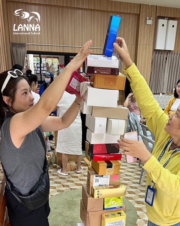 Parents collaborating on a stacking challenge during an Early Years workshop.