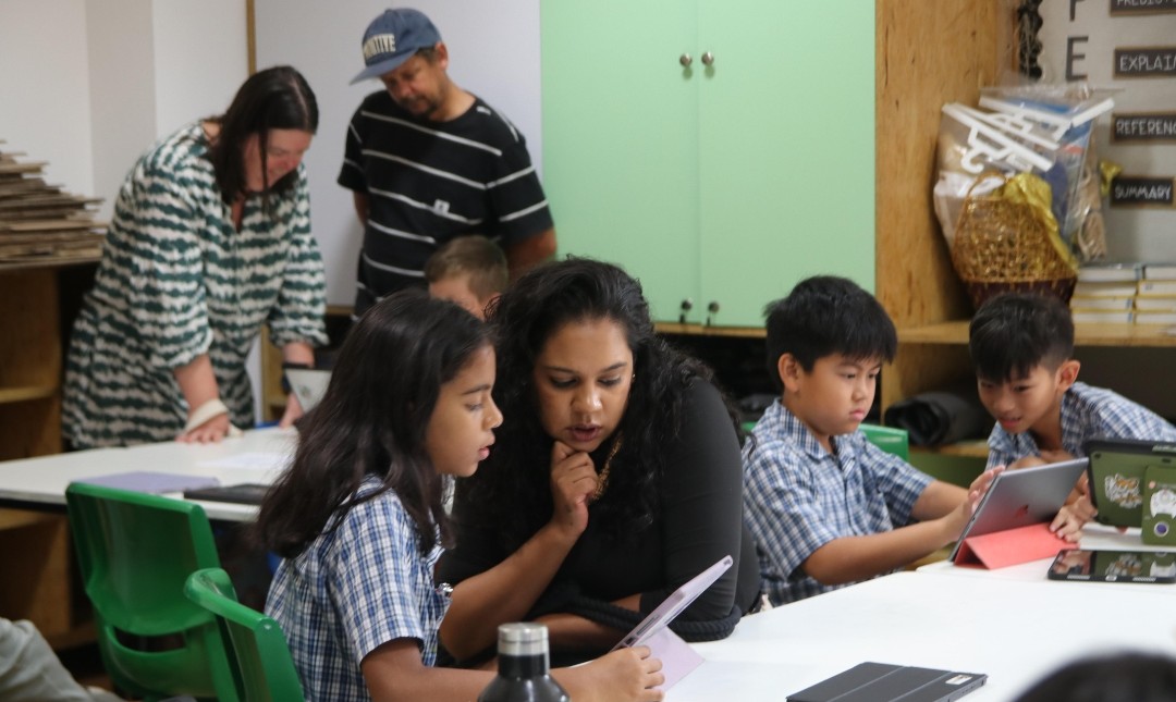A parent and child collaborate during a classroom-based activity.
