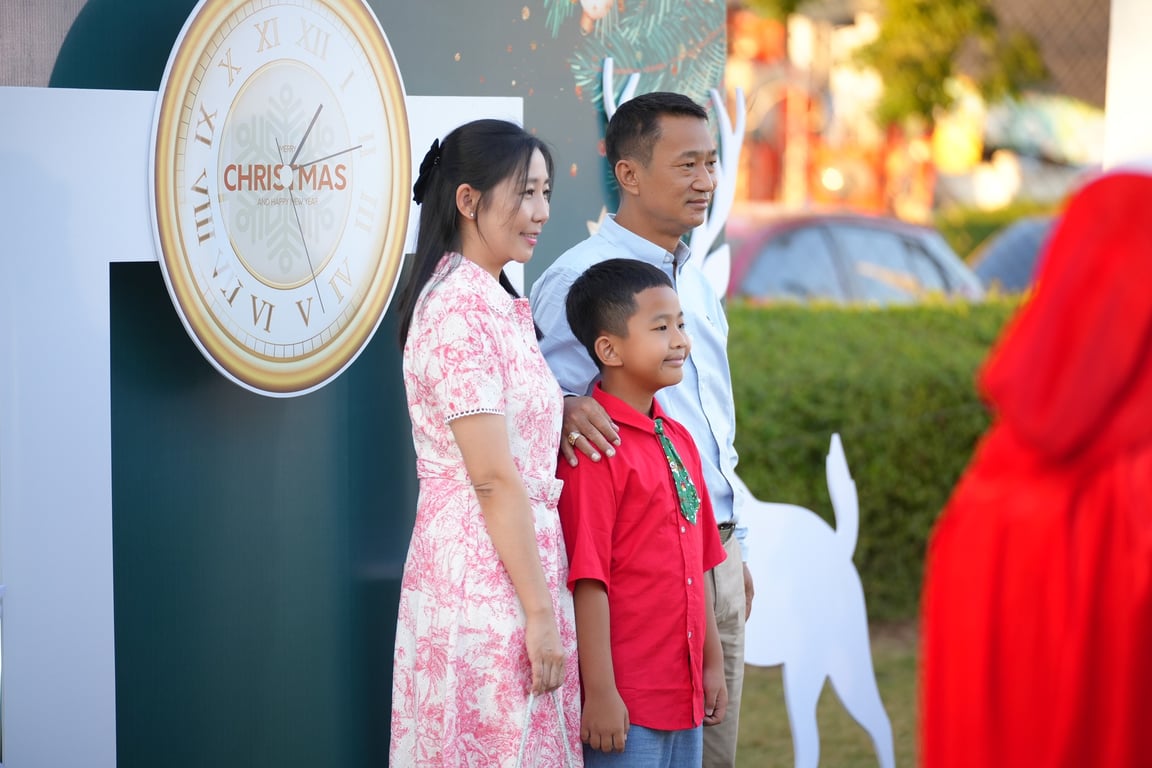 A family posing at the Christmas Event.