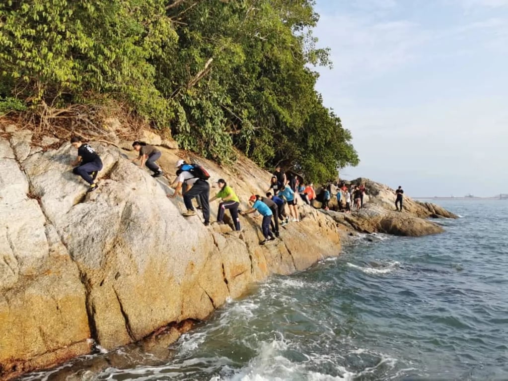 Students partaking in a coastal rock climbing and trekking adventure during an outdoor education trip