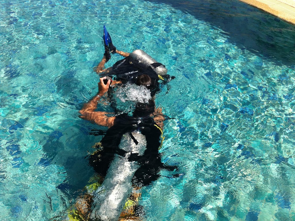 Student practicing scuba techniques in the training pool.