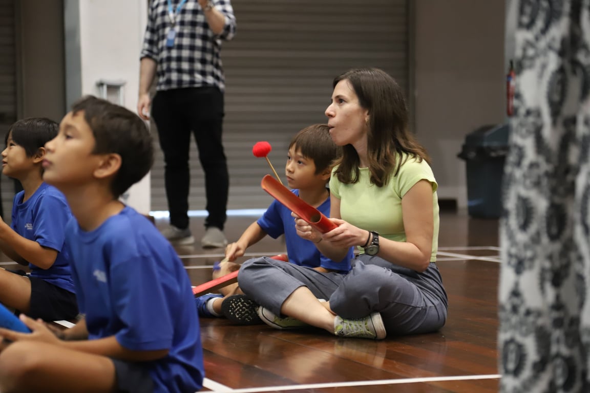 Parents and students join in with the Bamboo Orchestra performance at the school