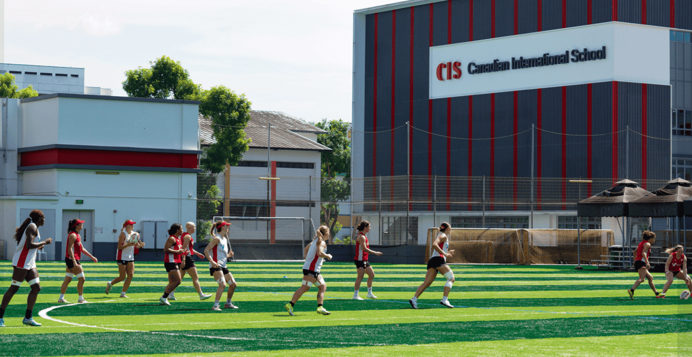 CIS students gear up for rugby practice on a sunny day on campus.