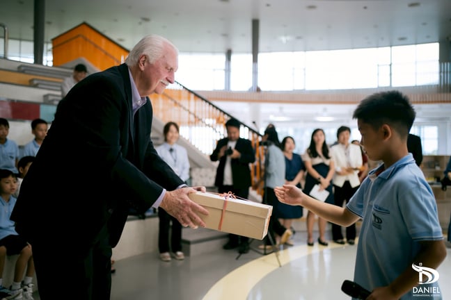 Farewell ceremony as a student offers a token of thanks.