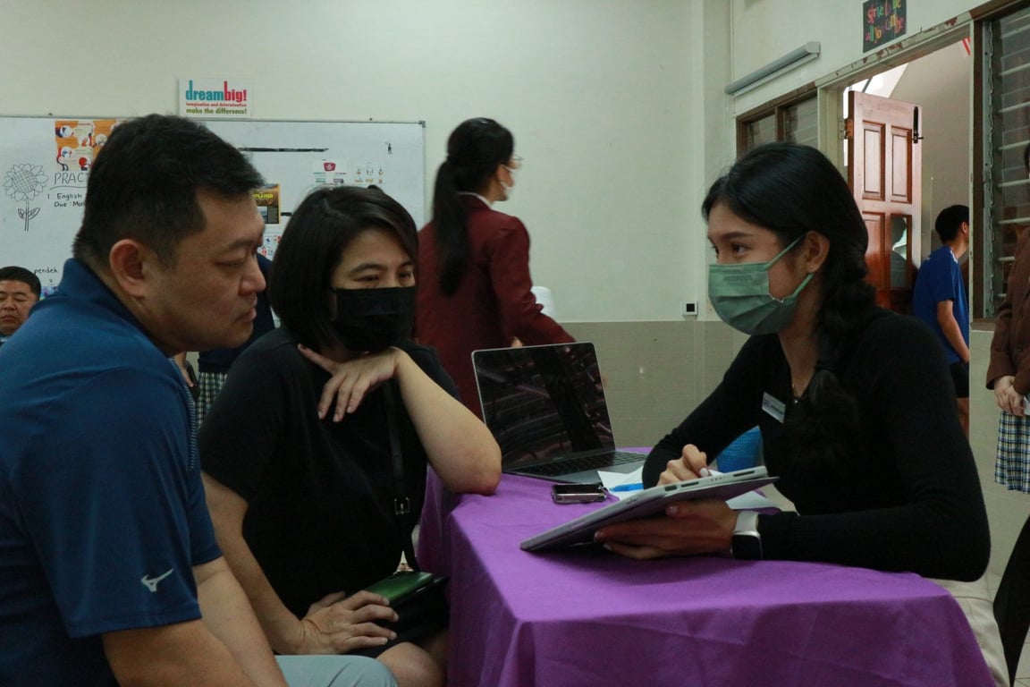 Parents and Teacher discussing their child's progress at the Parent-Teacher meeting.