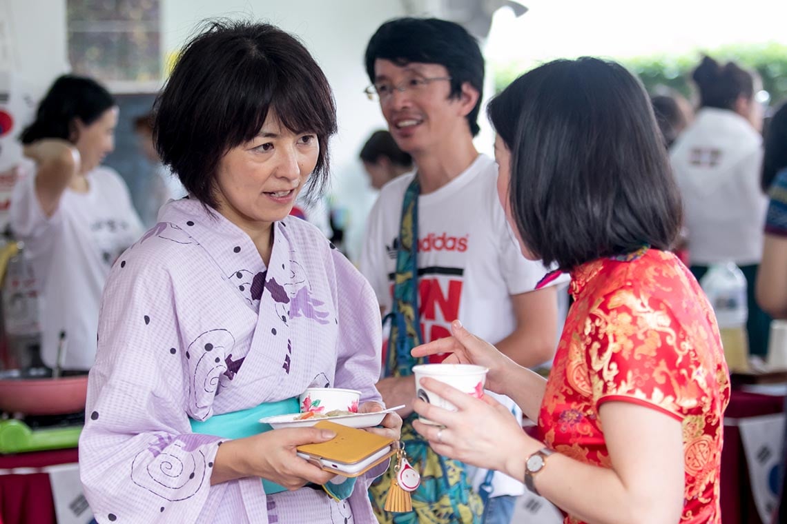 Parents sharing food and conversation at International Day.