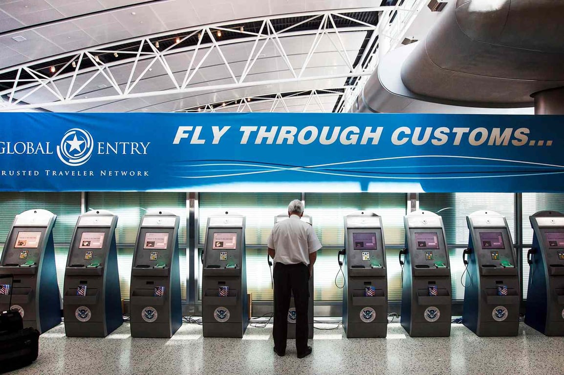 a traveller is standing at the Global Entry Kiosk.