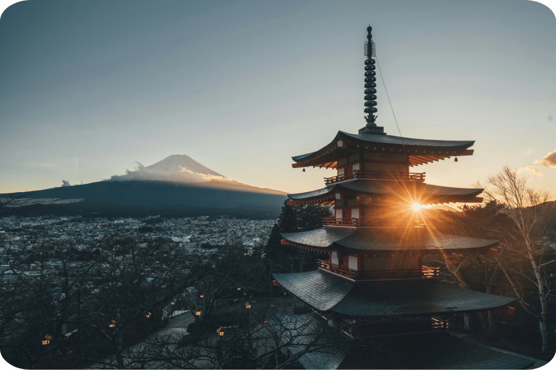 A picture with a Japanese temple in the foreground and a mountain in the back.