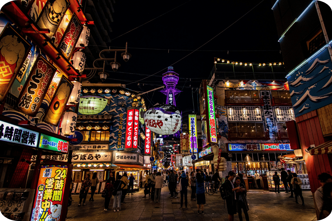 Vibrant market at night, plenty of people visiting different restaurants.
