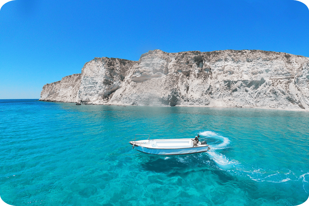 white and blue boat on crystal clear blue water
