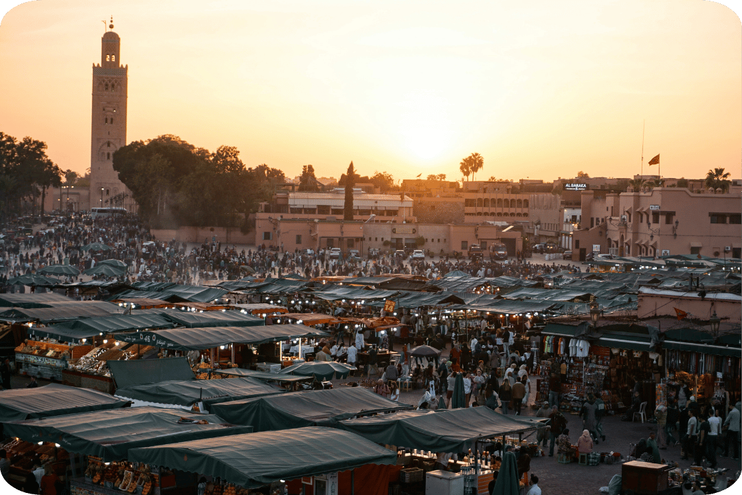 A busy market with plenty of stalls and people.