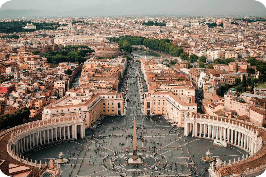A view of Rome from above, showing a circular structure of pillars circling a town centre.
