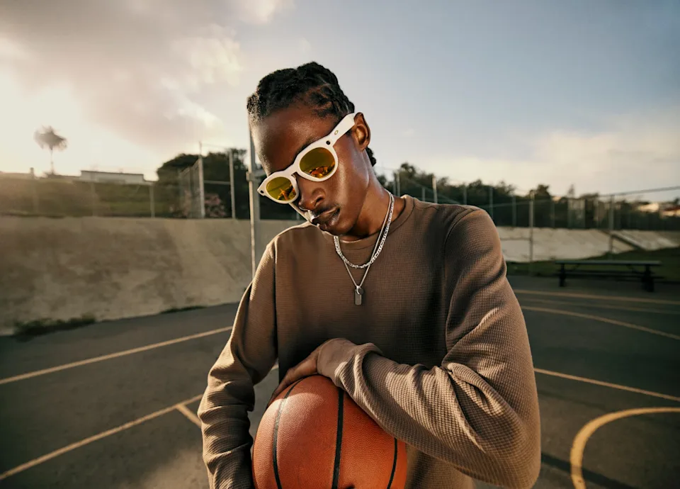 A person wearing Oakley Meta HSTN smart glasses and holding a basketball. | Threadsaver.in
