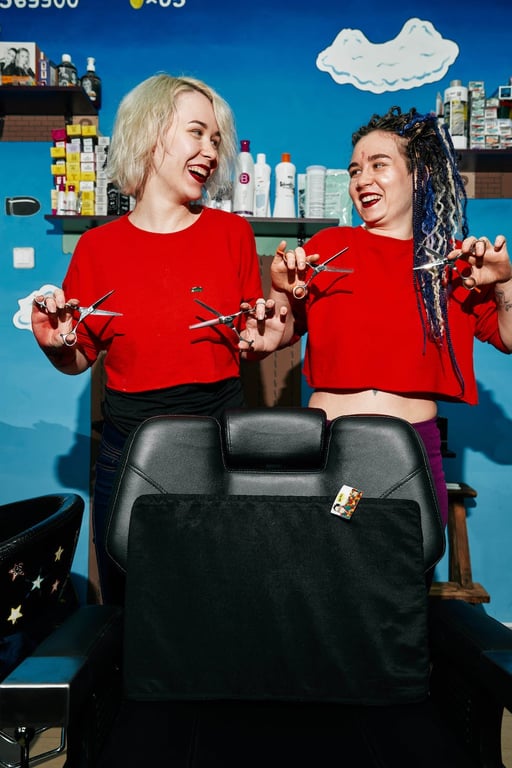 Photograph of Hairdressers with Scissors Looking at Each Other