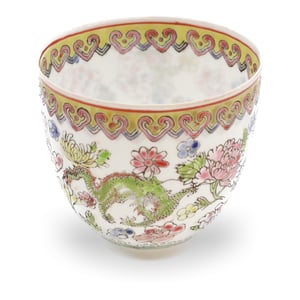 Chinese eggshell porcelain cup hand-painted with dragon and floral motifs, intricate antique Chinese teacup design close up