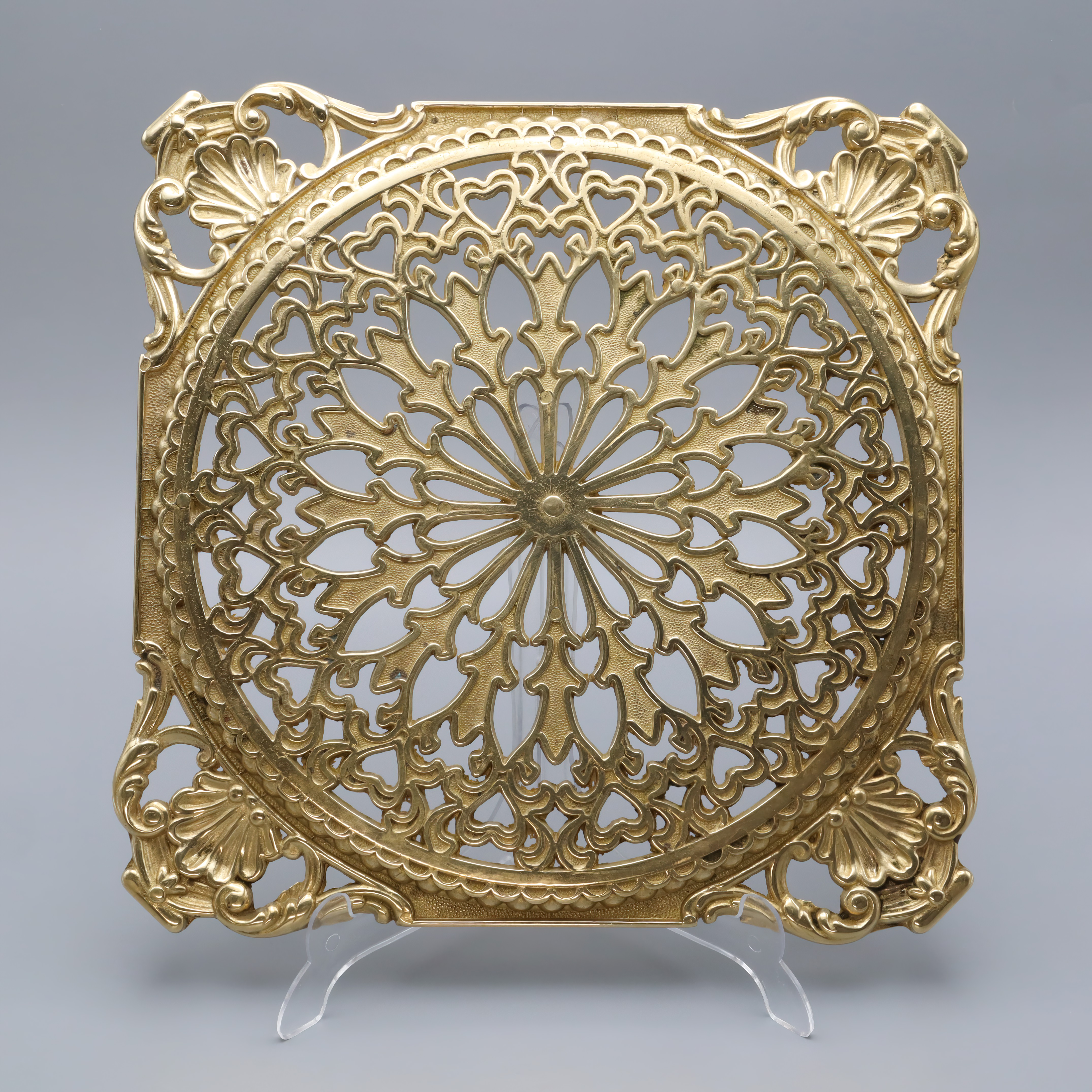 Antique brass trivet with intricate floral and heart pattern, vintage decorative metal trivet for kitchen or home decor