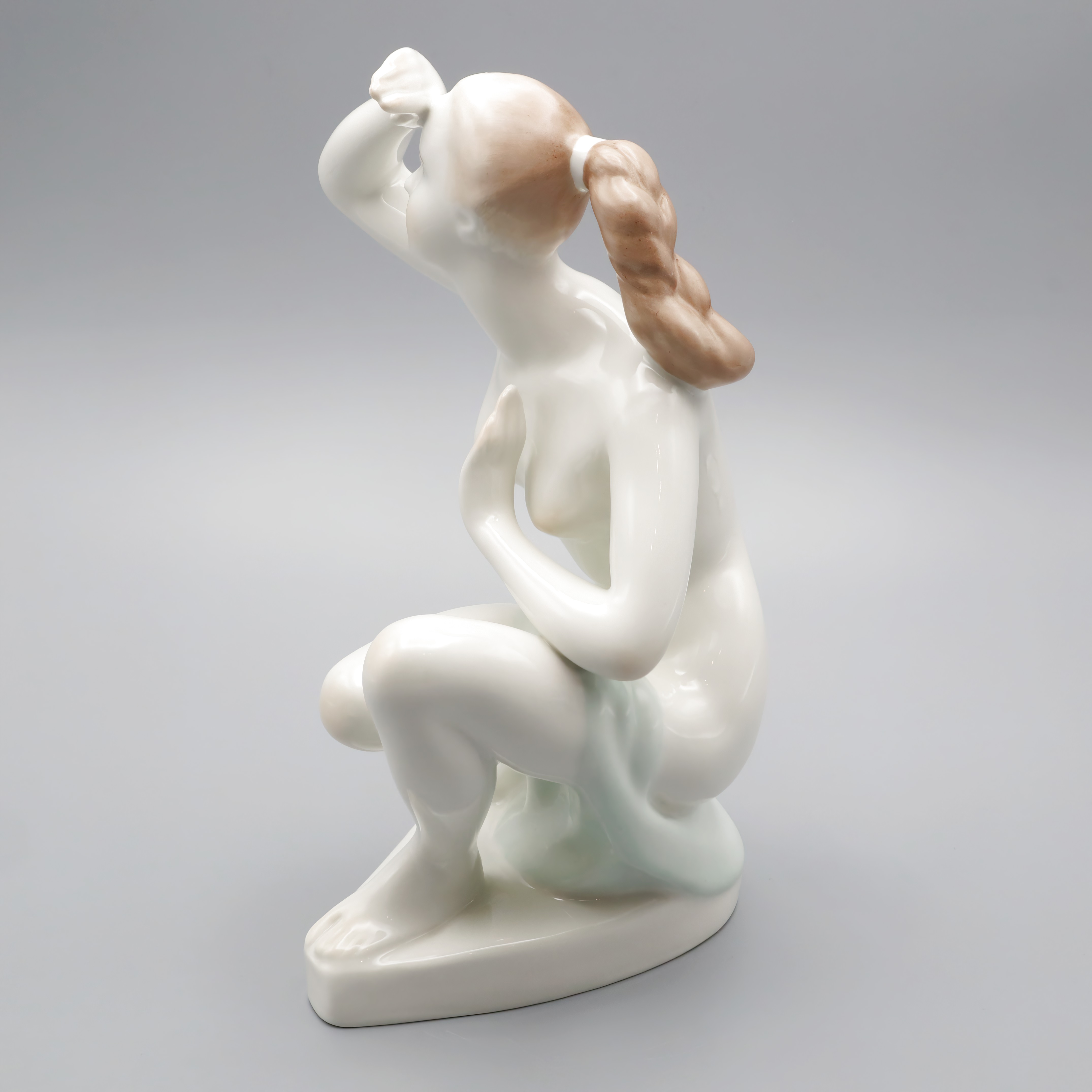 Elegant Lady Statue porcelain figurine with braided hair, detailed view of graceful female sculpture on neutral background