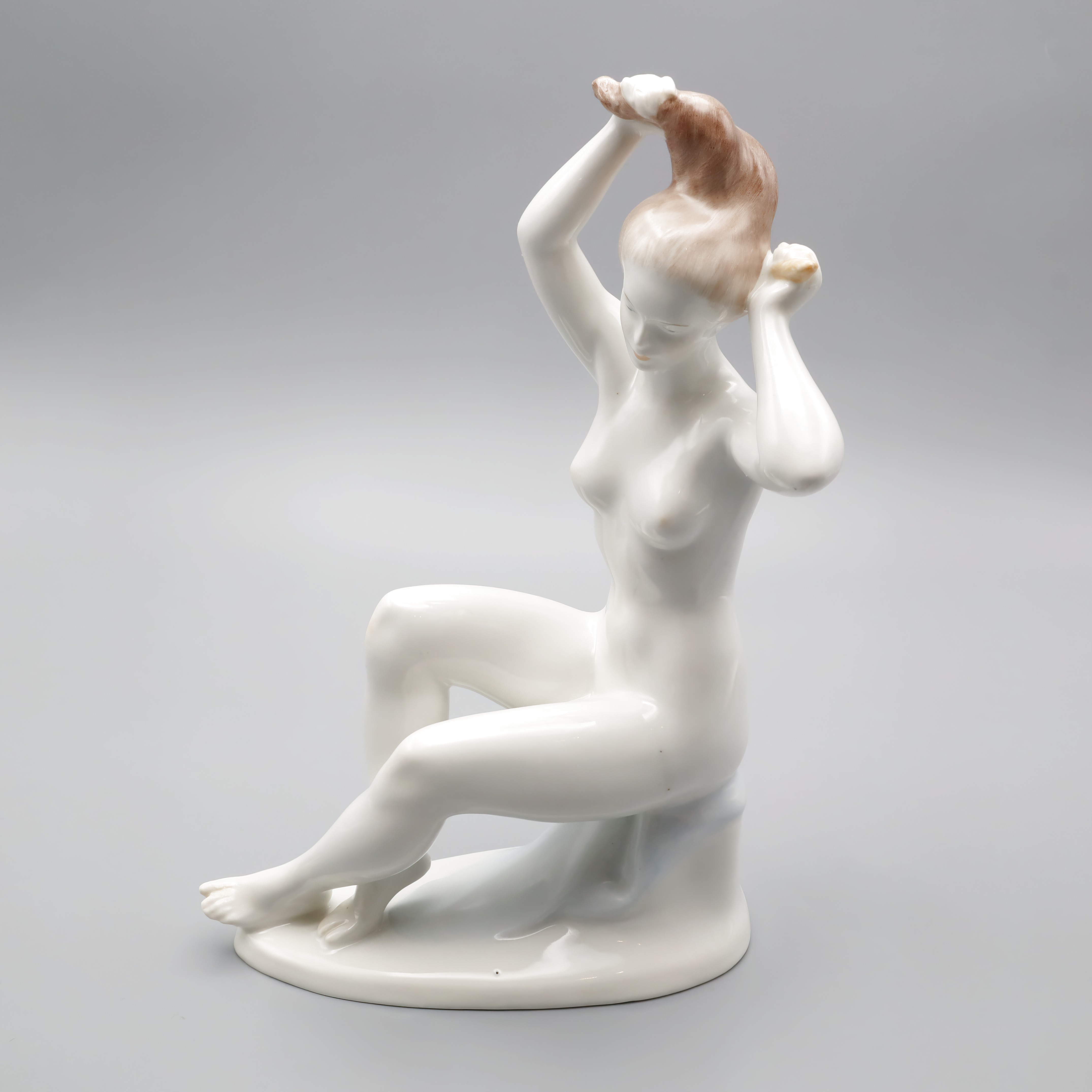 Nude Lady Figurine porcelain sculpture of a seated woman arranging her hair, elegant ceramic art decor