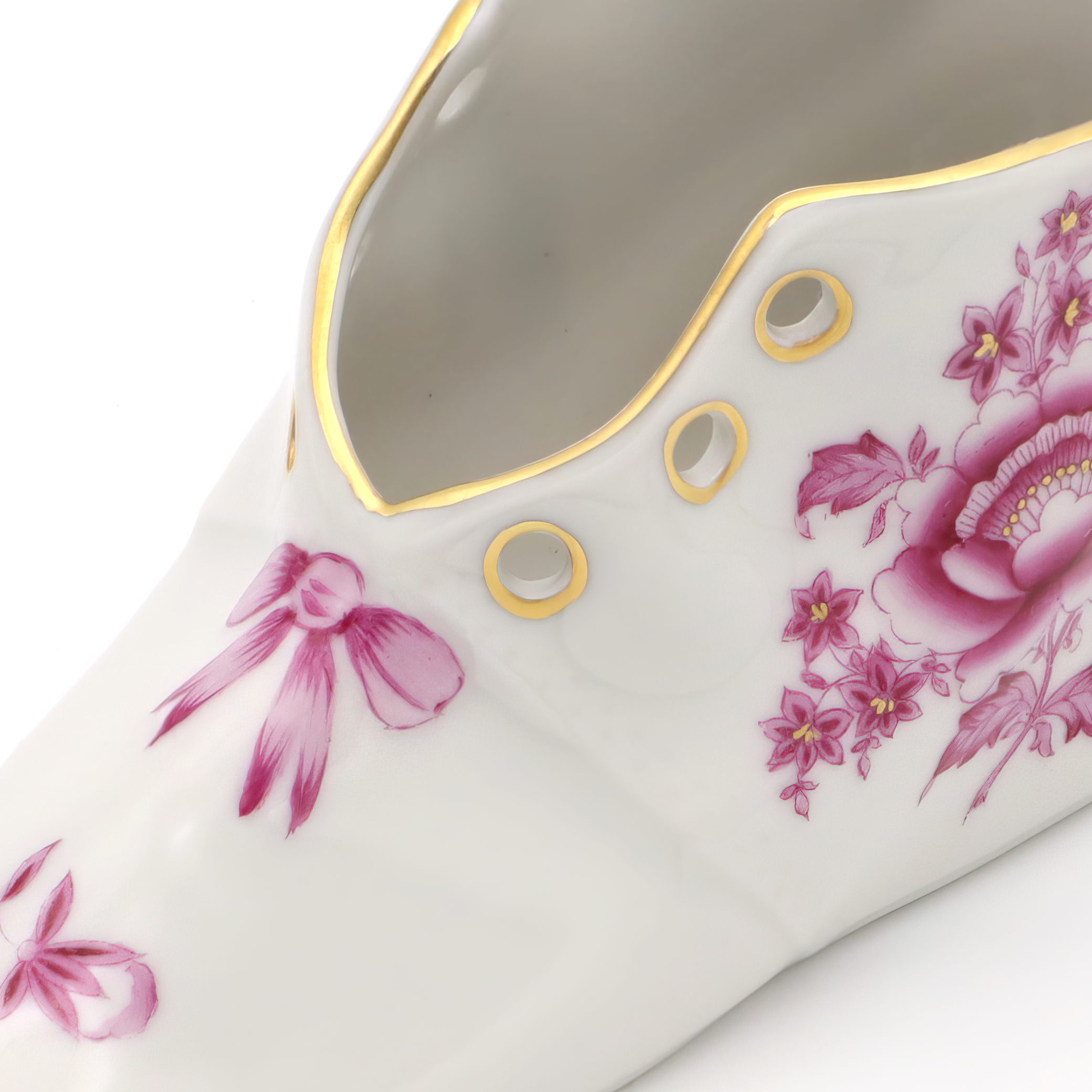 Herend Vintage Porcelain Baby Shoe close up with hand-painted floral and ribbon design, gold trim, collectible decorative porcelain