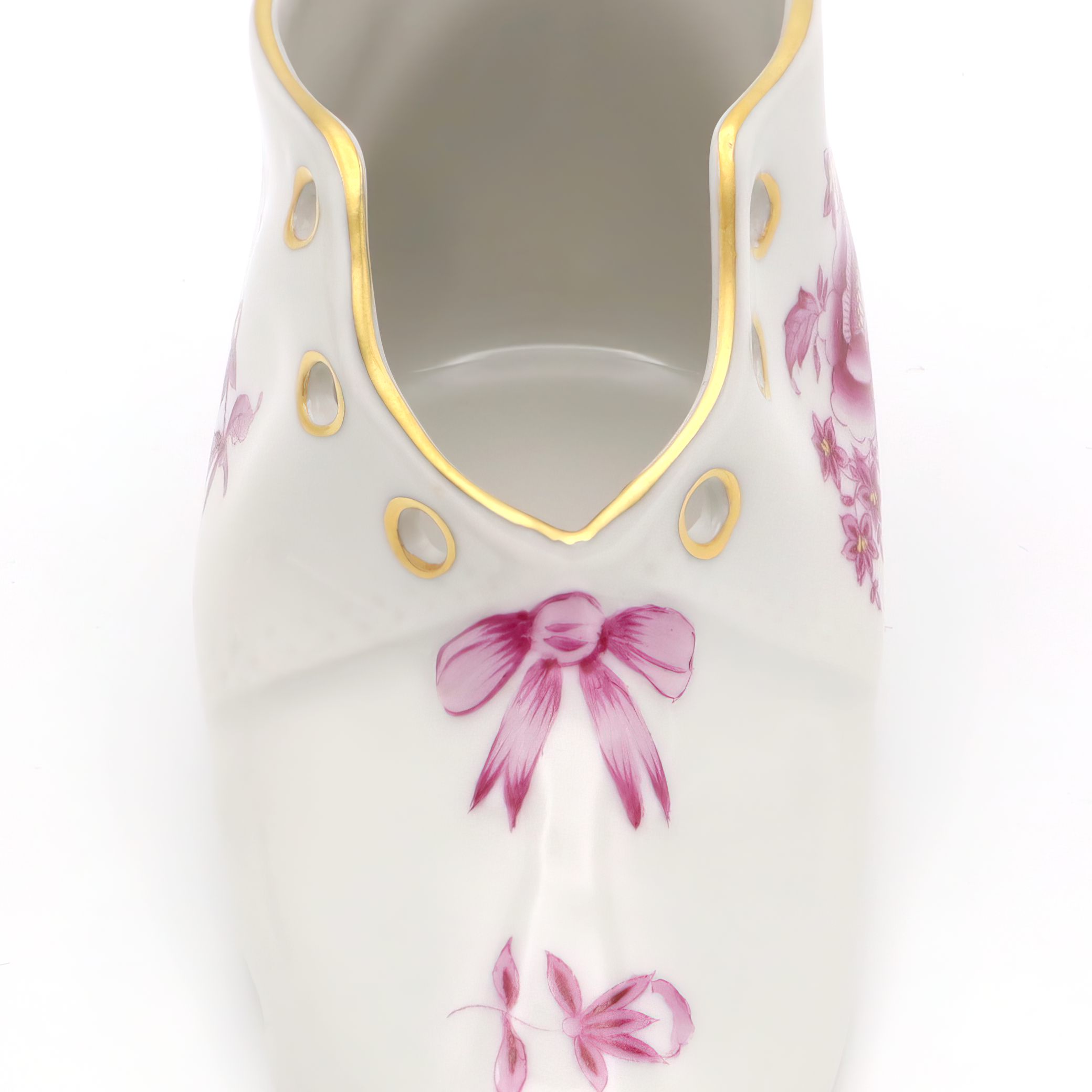 Herend vintage porcelain baby shoe close up with hand-painted pink floral design and gold accents