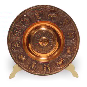 Zodiac copper plate with embossed astrological signs and sun motif, detailed view