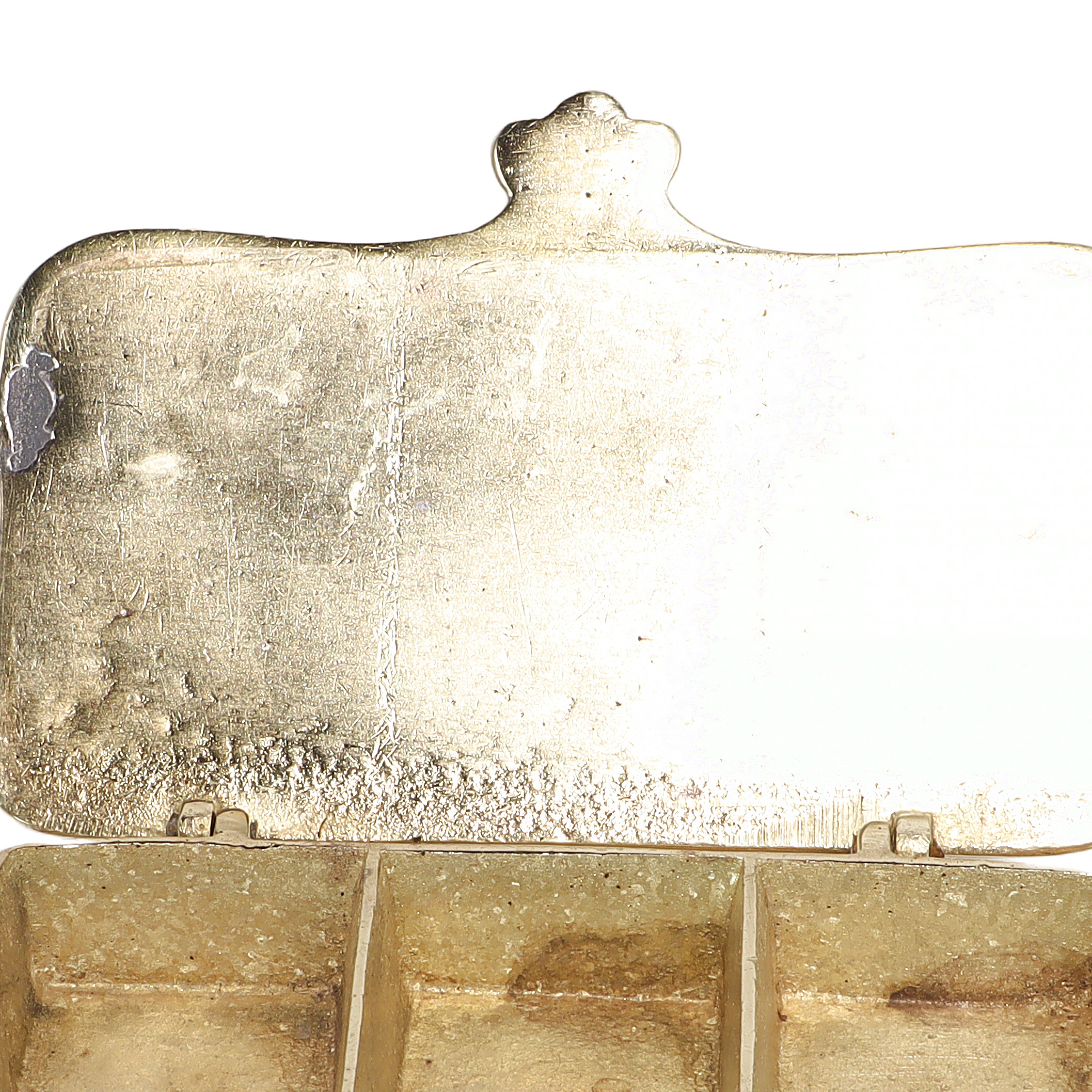 Brass stamp box close up showing interior compartments and aged patina