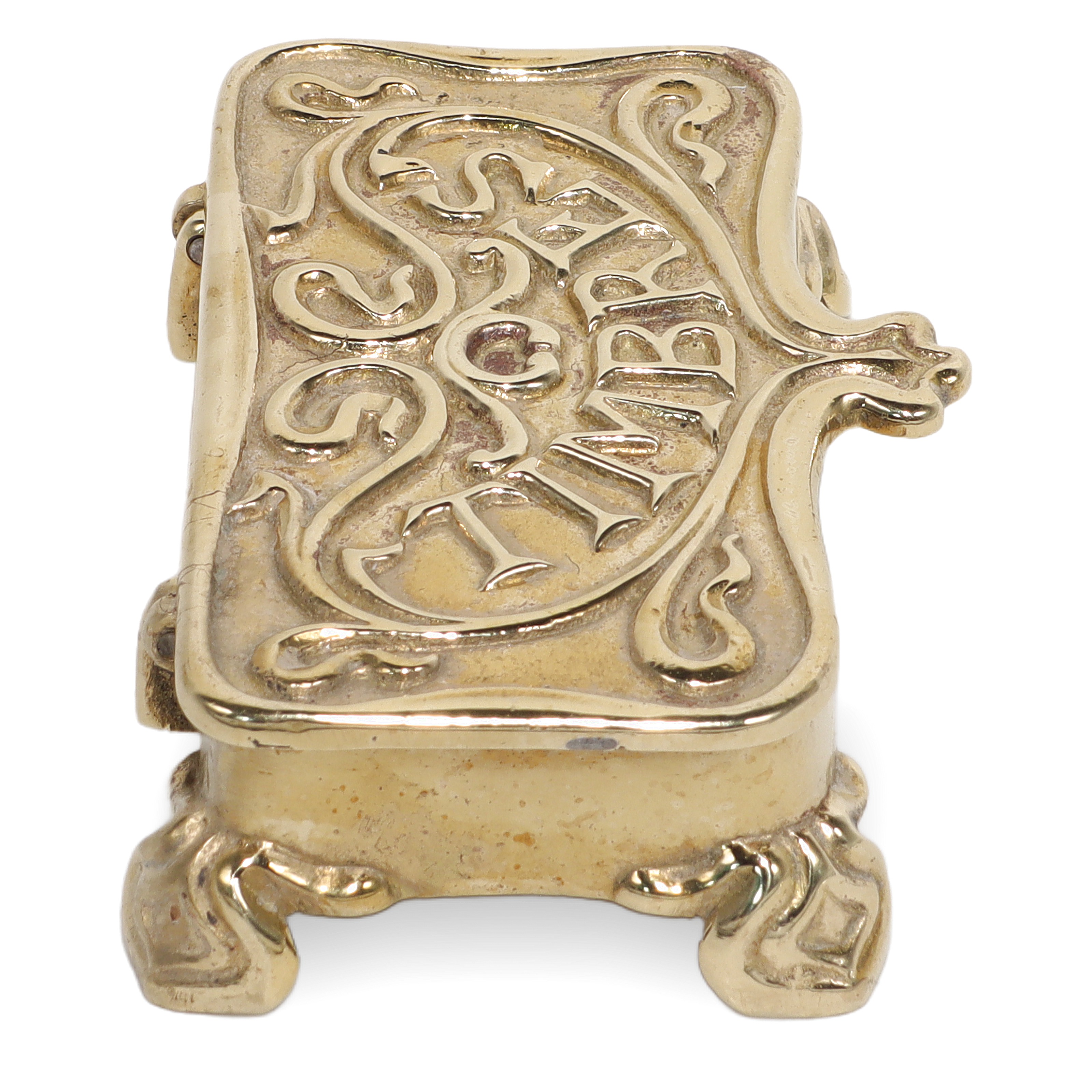 Brass stamp box ornate antique collectible close up with decorative lid and feet