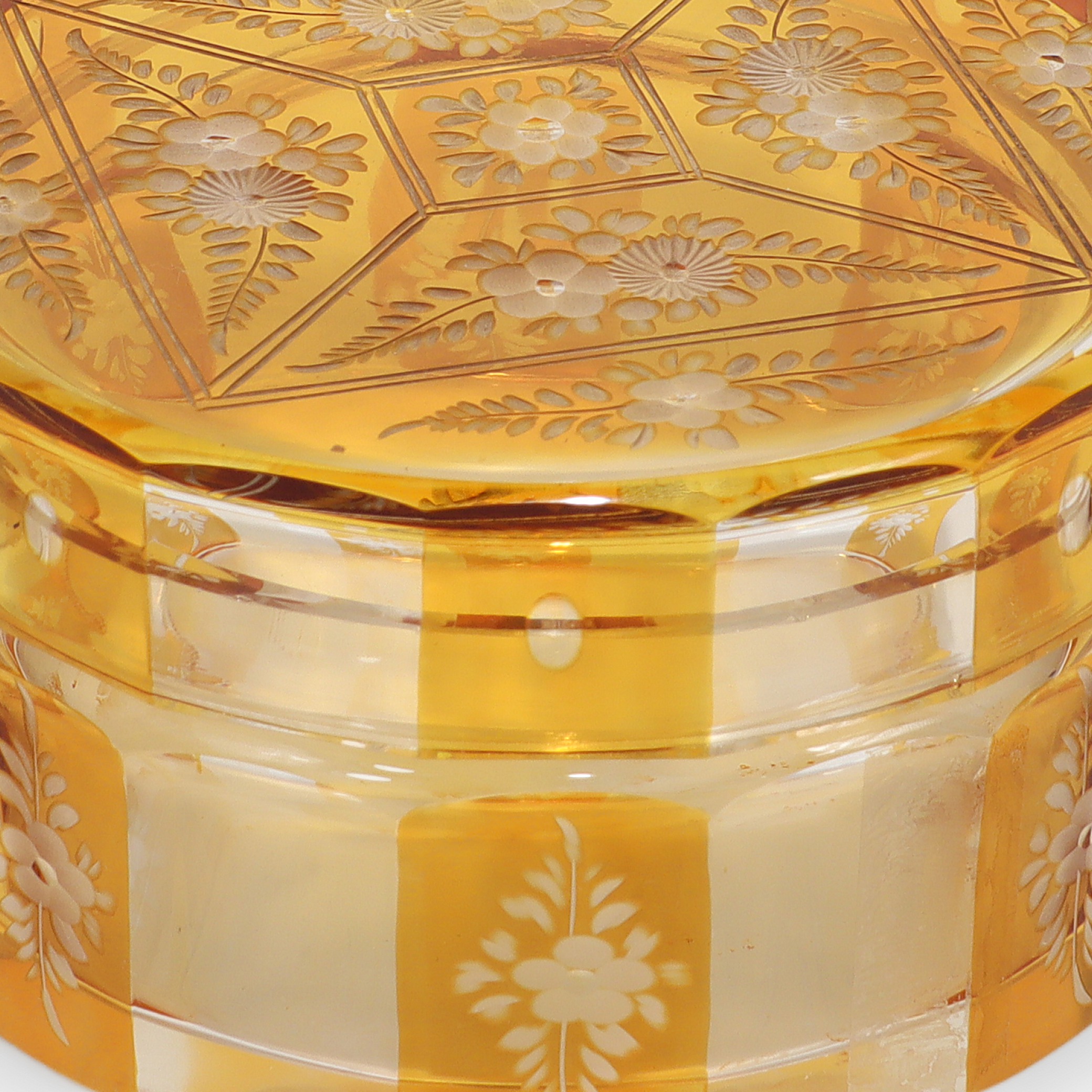 Bohemian amber cut glass trinket box close up showing floral engraving and Art Deco vintage design