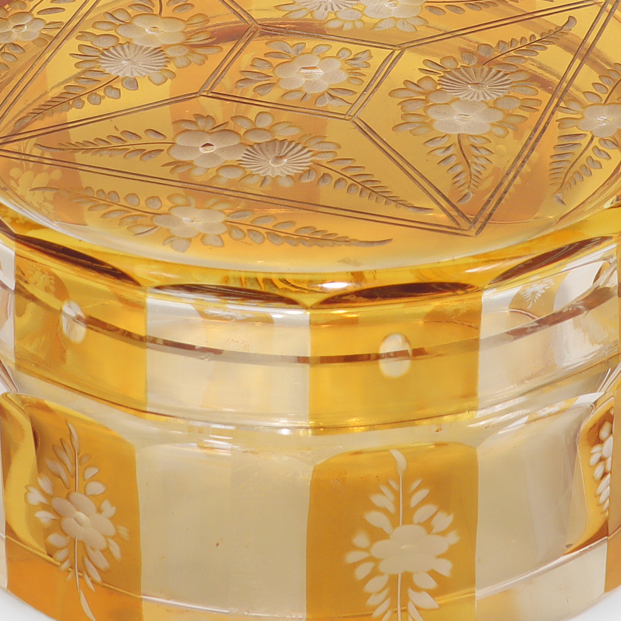 Bohemian amber cut glass trinket box close up, floral engraved Art Deco vintage collectible