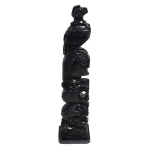 Stone totem pole sculpture vintage hand-carved indigenous art detailed side view