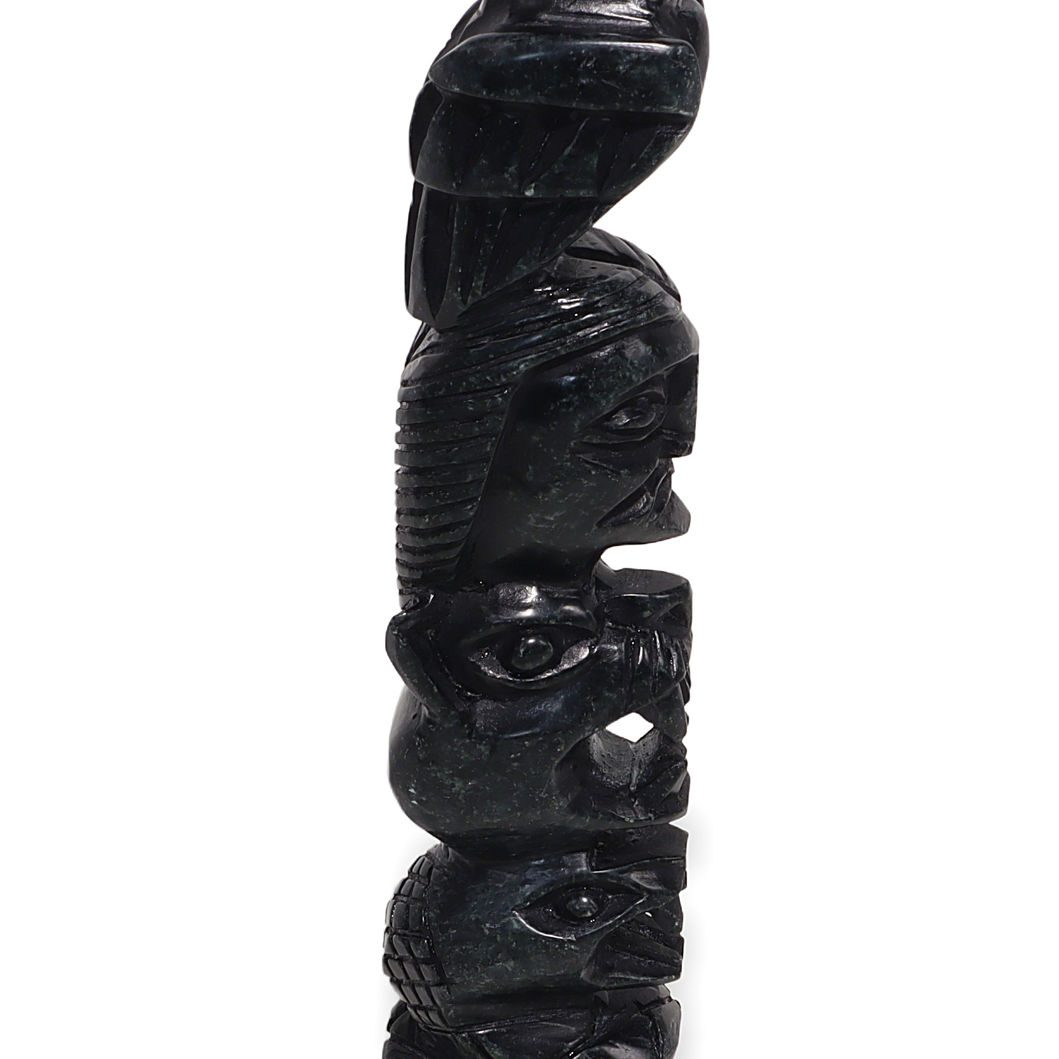 Stone totem pole close up, vintage carved indigenous art sculpture detailed side view