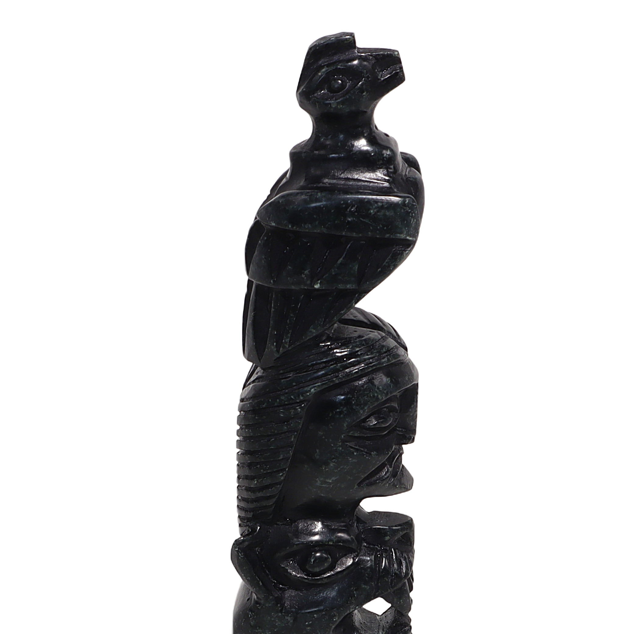 Totem pole stone sculpture close up, detailed carving of vintage indigenous art