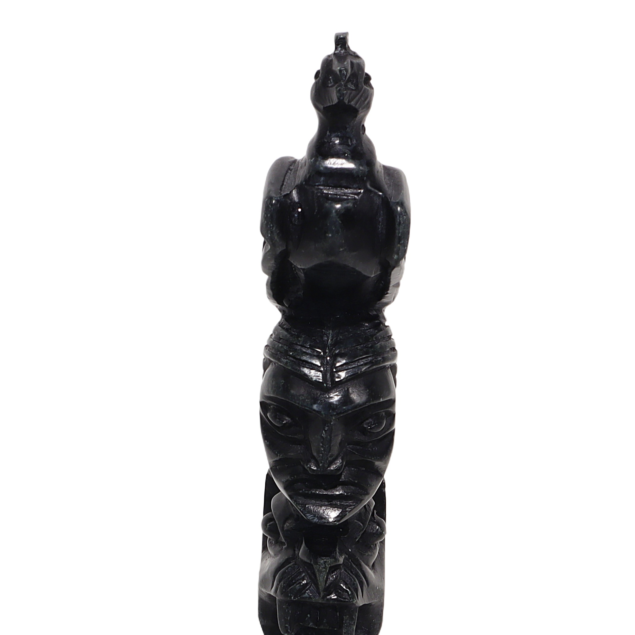 Totem pole stone sculpture close up, vintage hand-carved tribal art statue