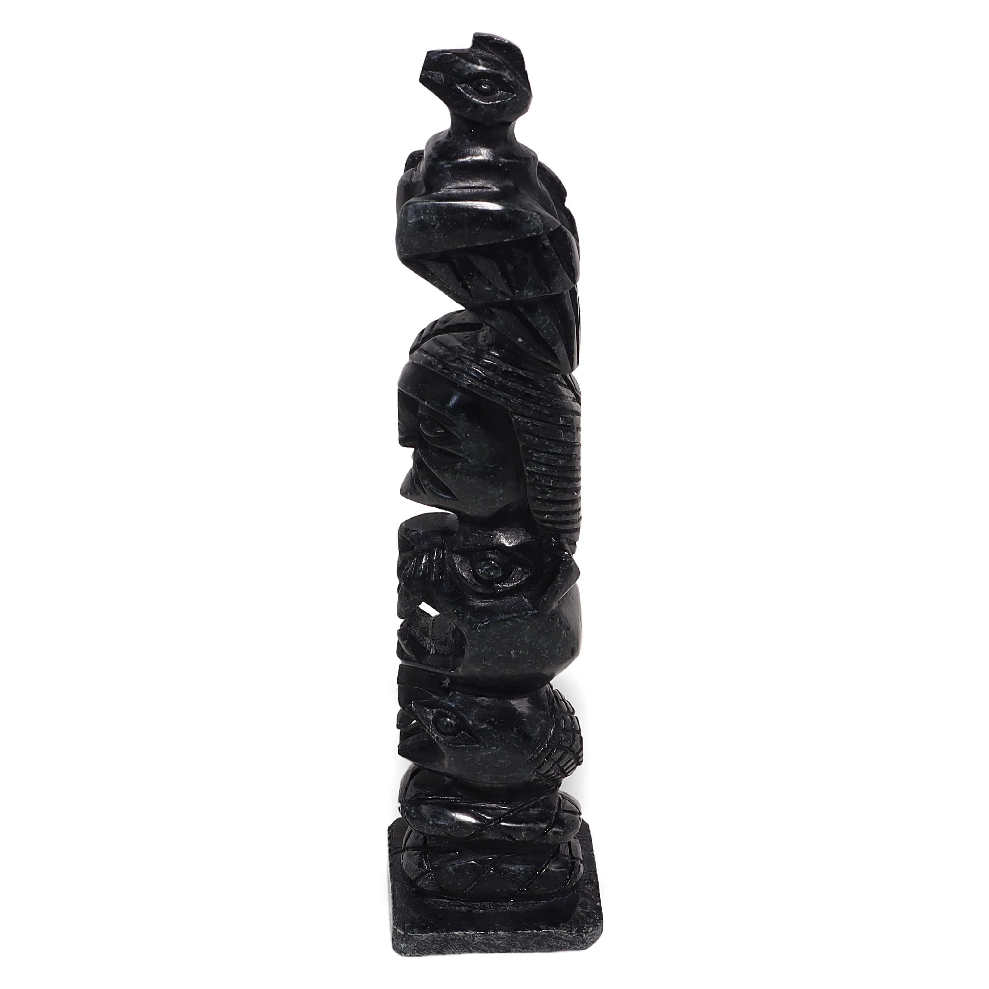 Totem pole vintage carved stone sculpture with intricate tribal designs and animal figures, side profile