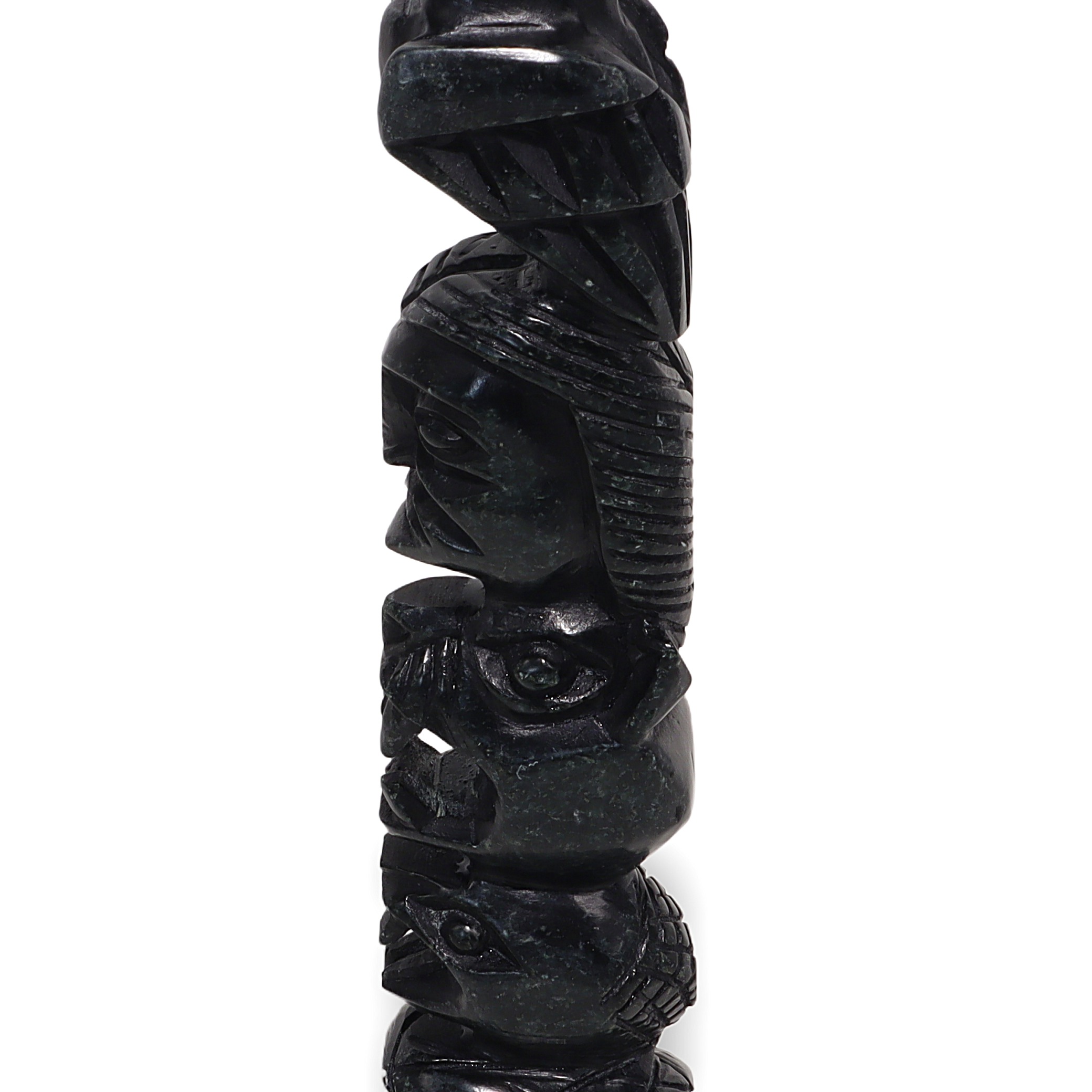 Stone totem pole sculpture close up showing intricate vintage carving details