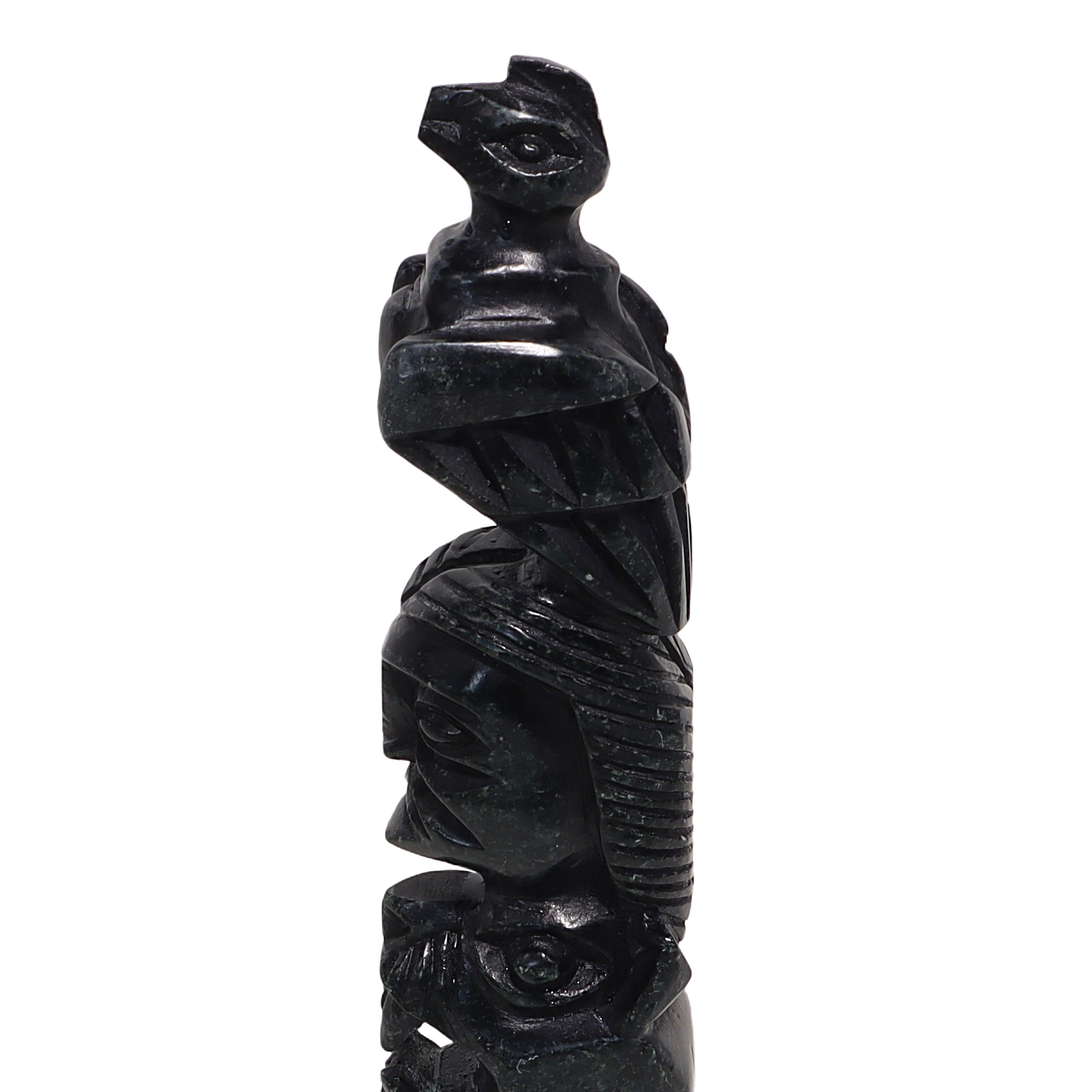 Stone totem pole sculpture close up, vintage hand-carved indigenous art with animal and human figures