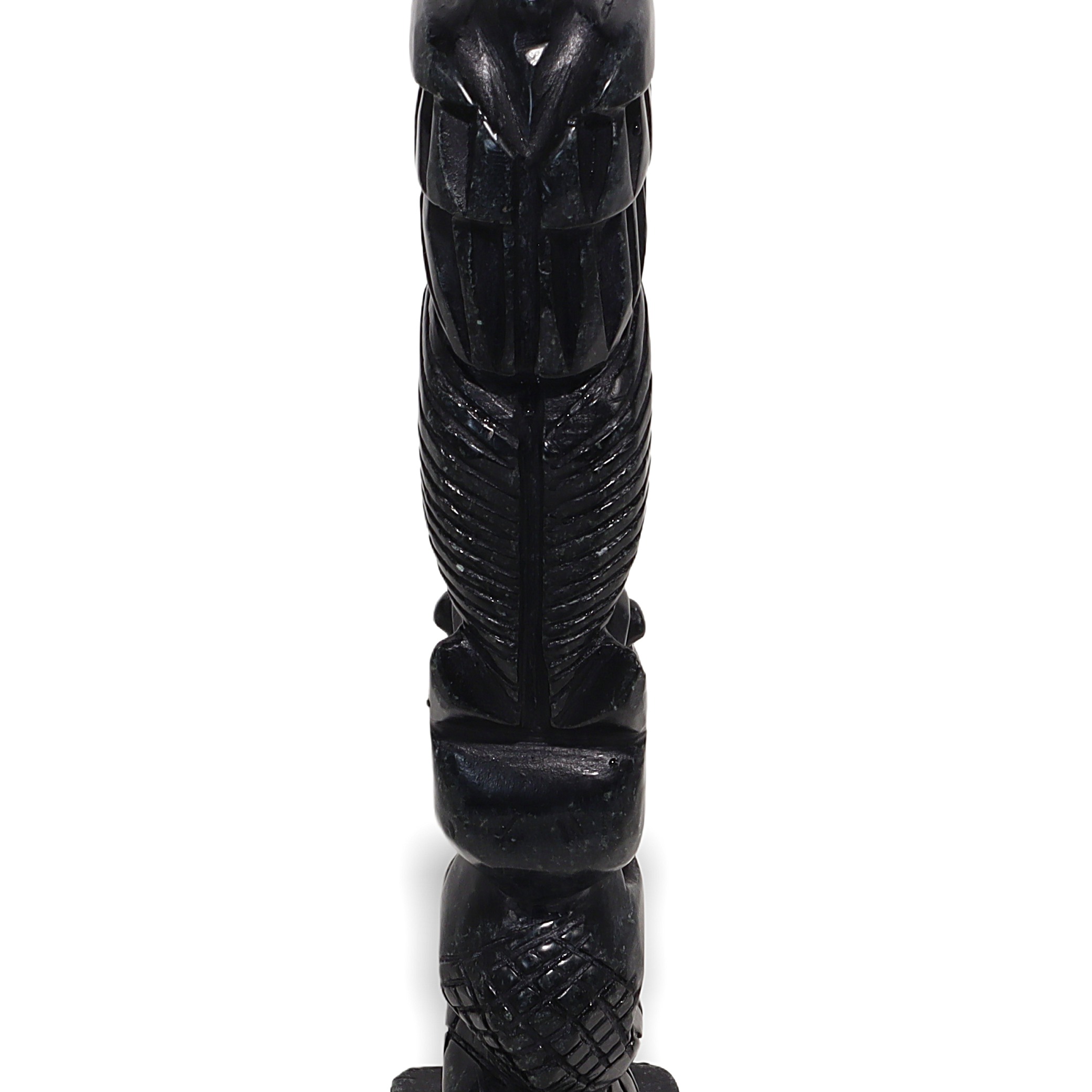 Stone totem pole sculpture base close up, vintage carved tribal art detailed bottom section